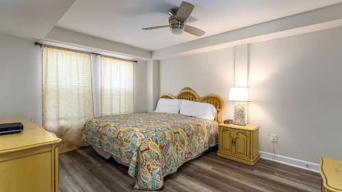 a bedroom with a bed and a ceiling fan at High Tide - 3rd Row - Crescent Beach Section in Myrtle Beach