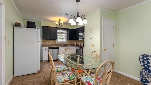 a kitchen with a table and chairs and a dining room at High Tide - 3rd Row - Crescent Beach Section in Myrtle Beach