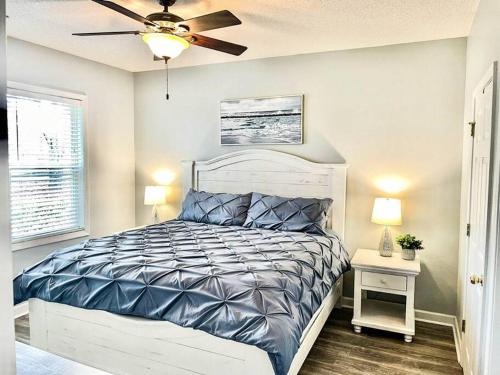 a bedroom with a bed and a ceiling fan at Barefoot Beach Haven: Resort Access in North Myrtle Beach
