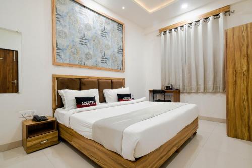 a bedroom with a large bed in a room at Aceotel Inn Flamingo Vijay Nagar in Indore