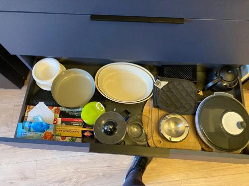 a drawer full of pots and pans on a table at Comfort and tranquility near Lyon and Groupama Stadium, 4 personnes in Meyzieu