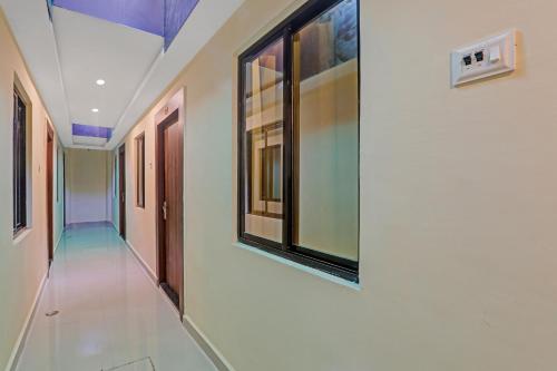 a corridor of a hospital with a window on the wall at Collection O Boutique Heritage House in Allahābād