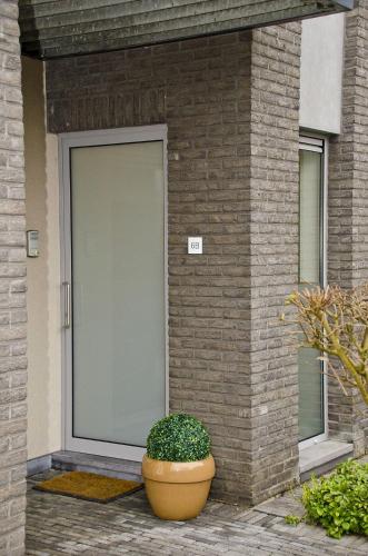 a plant in a pot in front of a building at Hotel Apartments Belgium 1 - HAB 1 in Geel