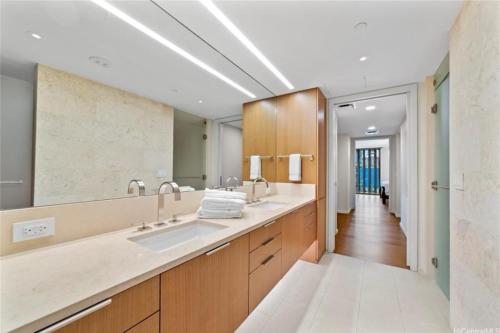 a bathroom with a sink and a large mirror at Park lane 2/2 in Honolulu