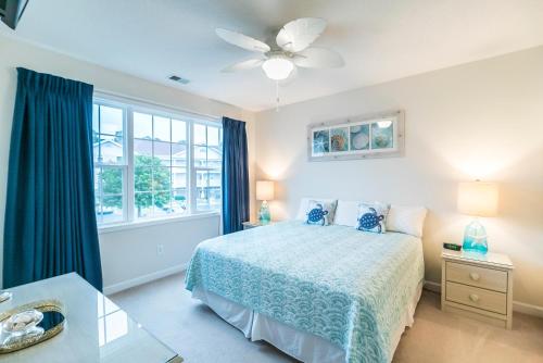 a bedroom with a bed and a ceiling fan at Barefoot Resort - Cypress Bend 123 - Windy Hill in North Myrtle Beach