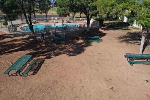 an empty playground with a swimming pool and trees at Quality Inn View of Lake Powell - Page in Page