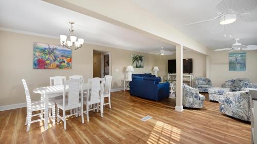 a dining room and living room with a table and chairs at Blue Moon - 3rd Row - Ocean Drive Section in Myrtle Beach