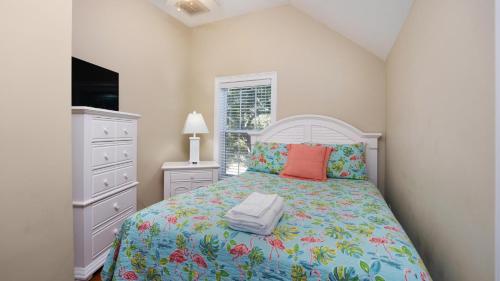 a bedroom with a bed and a dresser and a window at Blue Moon - 3rd Row - Ocean Drive Section in Myrtle Beach