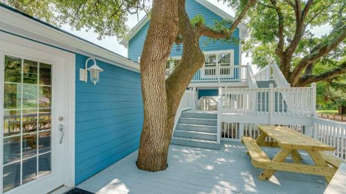 a blue house with a tree and a picnic table at Blue Moon - 3rd Row - Ocean Drive Section in Myrtle Beach