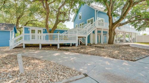 a blue house with a white porch and a tree at Blue Moon - 3rd Row - Ocean Drive Section in Myrtle Beach