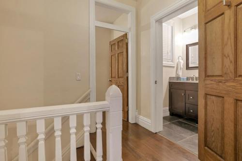 a hallway with a staircase and a sink in a home at OSU and Short North 4 Bedroom Patio and Garage with EV in Columbus