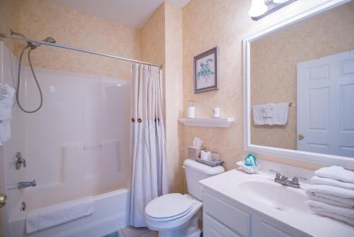 a bathroom with a toilet and a shower and a sink at Barefoot Resort - Arbor Trace 523 - Windy Hill in North Myrtle Beach