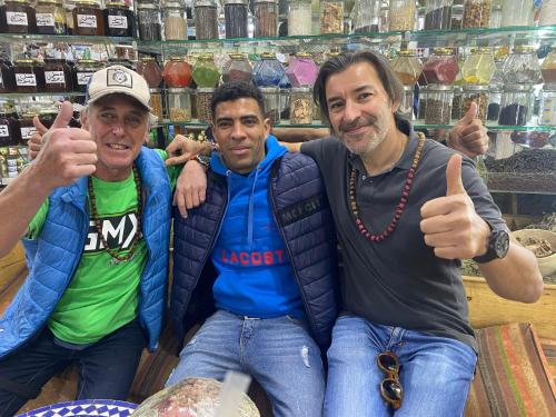a group of three men giving the thumbs up at Hamada Activities Luxury Camp in Merzouga