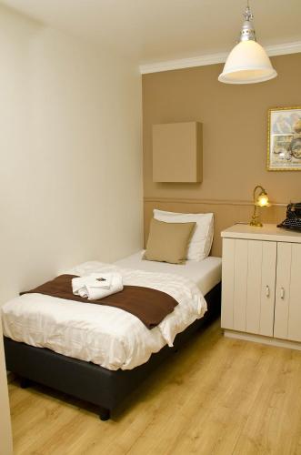 a bedroom with a bed and a lamp at Hotel Apartments Belgium 1 - HAB 1 in Geel
