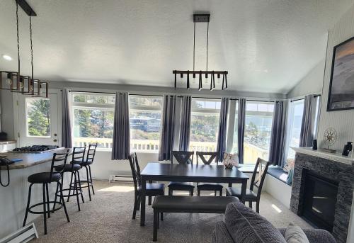 a kitchen and dining room with a table and chairs at Inn at Arch Rock in Depoe Bay