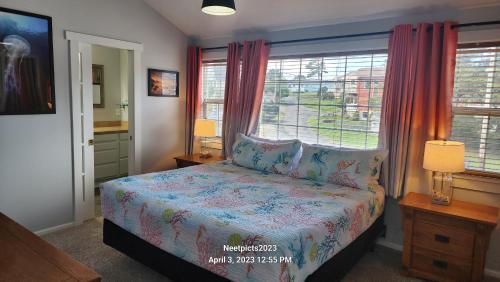 a bedroom with a bed and a window at Inn at Arch Rock in Depoe Bay