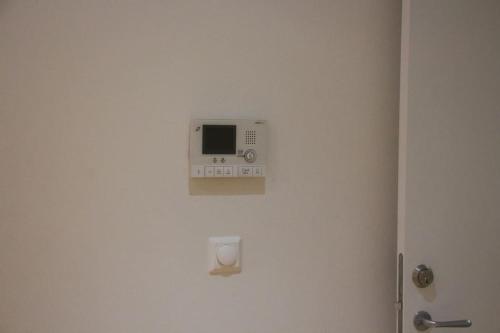 a microwave on the wall of a bathroom at Small, quiet and central studio i Oslo in Oslo