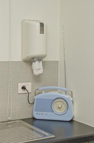 a small blue radio sitting on a counter in a room at Hotel Apartments Belgium 1 - HAB 1 in Geel