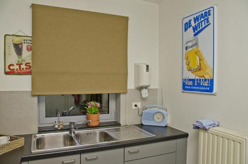 a kitchen counter with a sink and a window at Hotel Apartments Belgium 1 - HAB 1 in Geel