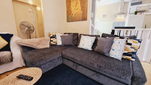 a living room with a couch with pillows on it at Stylish 2 Bedroom Apartment, Leeds Centre + Free Parking in Leeds