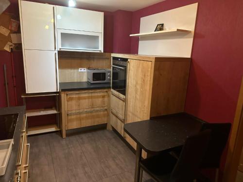 a small kitchen with a table and a microwave at Hotel Bender in Eschweiler