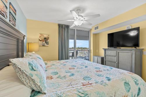 a bedroom with a bed and a flat screen tv at Tilghman Beach & Golf Resort 6015 - 2nd Row - Cherry Grove in Myrtle Beach