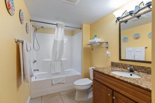 a bathroom with a toilet and a shower and a sink at Tilghman Beach & Golf Resort 6015 - 2nd Row - Cherry Grove in Myrtle Beach