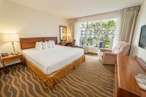 a hotel room with a bed and a large window at Irazú Hotel & Studios in San José