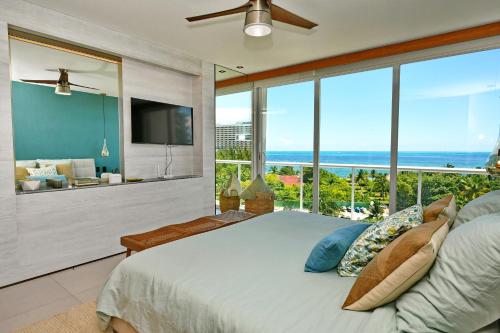 a bedroom with a large bed with a view of the ocean at Beachfront apartment Blue Vista in Cancún