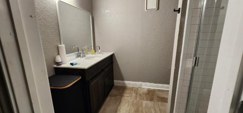 a bathroom with a sink and a mirror at Large Condo in the heart of Las Colinas, near Dallas in Irving