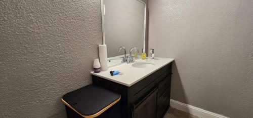 a bathroom with a sink and a mirror at Large Condo in the heart of Las Colinas, near Dallas in Irving