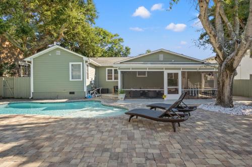 a home with a swimming pool and a house at Beaching On The Dunes - 3rd Row - Windy Hill Section in Myrtle Beach