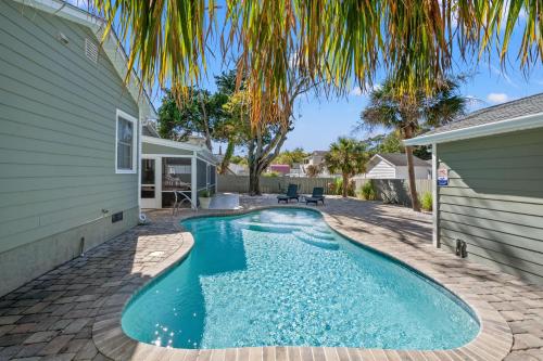 a swimming pool in the backyard of a house at Beaching On The Dunes - 3rd Row - Windy Hill Section in Myrtle Beach