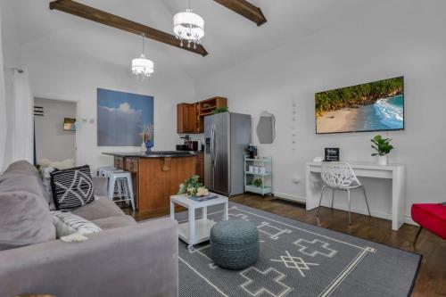 a living room with a couch and a kitchen at The Village Cottage in Columbus