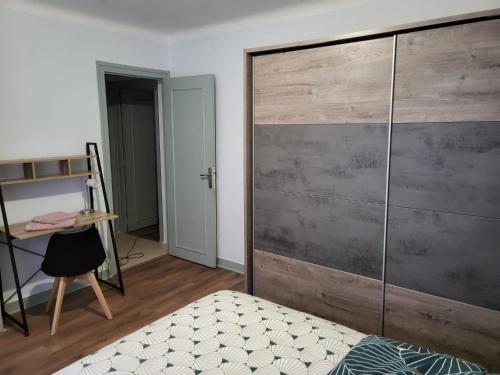 a bedroom with a large wooden sliding door at 2 chambres chez l'habitant in Poitiers