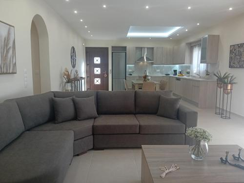 a living room with a couch and a kitchen at Villa Sunset in Samos