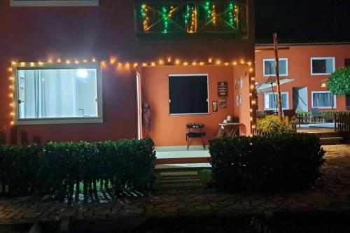 a house with christmas lights on the front of it at Linda Casa de Veraneio em Monte Gordo/Ba in Camacari