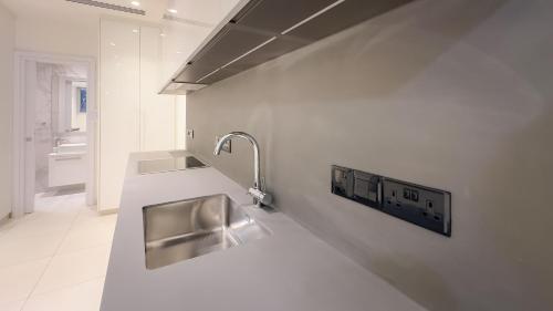 a kitchen with a stainless steel sink on the wall at City Napa Seaview Villas - Villa 4 in Ayia Napa
