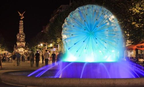 a large blue fountain with a large umbrella on it at Magnifique Studio pas loin centre-ville in Reims