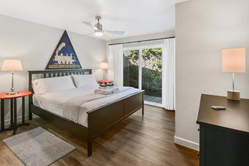 a bedroom with a large bed and a window at Seashore Delight in San Diego