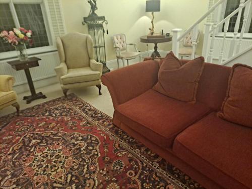 a living room with a couch and chairs and a rug at Lapley Manor Lodge in Gailey