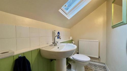 a bathroom with a sink and a toilet at Luxury 4 Bedroom Seaside Apartment - Glan Y Werydd House in Barmouth