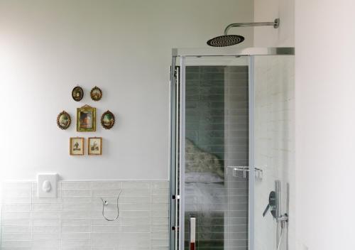 a shower with a glass door in a bathroom at Dimore Santojanni - Il Salotto dei Portici nel centro di Potenza in Potenza