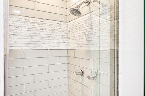 a bathroom with a shower with white subway tiles at Long Island Home 1 Mi to Downtown Garden City in Hempstead