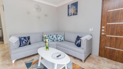 a living room with a couch and a table at Nely y Pietro share apartment in Punta Cana