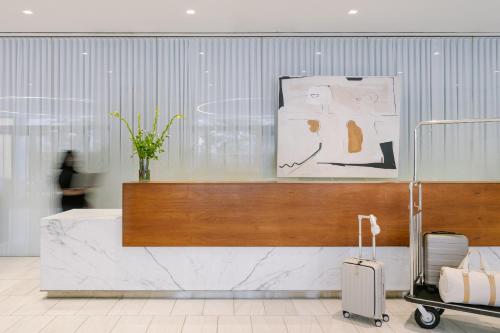 a lobby with a counter with a suitcase in a room at Sonder Battery Park in New York