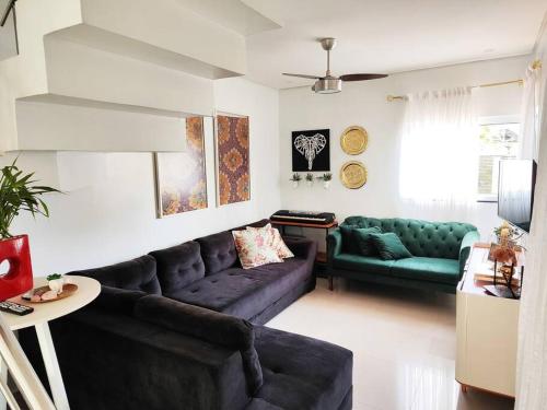 a living room with a couch and a table at Casa da Brisa in Foz do Iguaçu