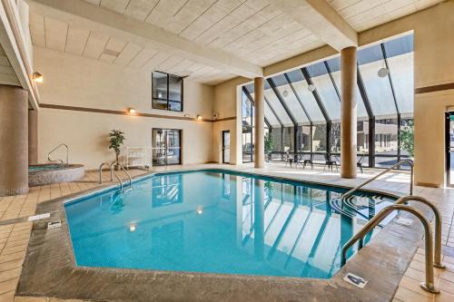 a swimming pool in a large building with a large window at LeConte Motor Lodge A Ramada by Wyndham in Gatlinburg