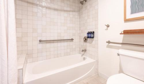 a white bathroom with a tub and a toilet at Islander Bayside Villas & Boatslips in Islamorada