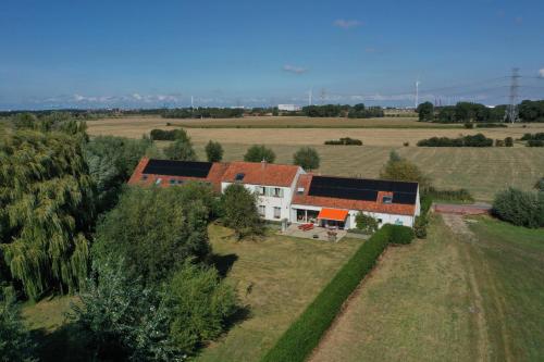 an aerial view of a house in a field at Polderlicht in Blankenberge